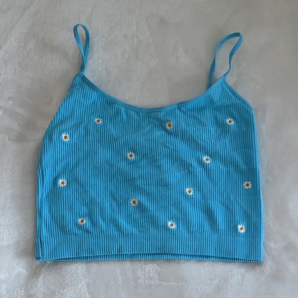 Blue cropped top with daisies all around.